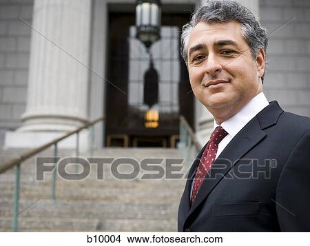 Portrait of a man standing on the steps of a courthouse and smiling View Large Photo Image Picture - Portrait of a man standing on the steps of a courthouse and smiling. Fotosearch