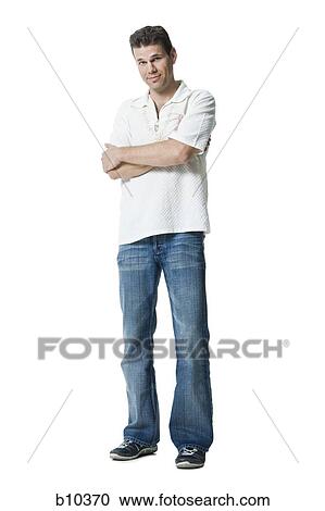 Stock Image - Portrait of a man standing with his arms crossed. Fotosearch