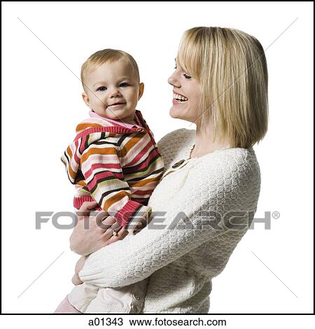 Portrait of a mother holding baby girl View Large Photo Image Stock Image - Portrait of a mother holding baby girl. Fotosearch