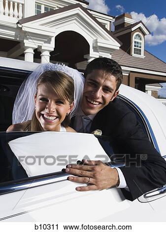 Portrait of a newlywed couple leaning out from a car window and smiling View Large Photo Image Stock Image - Portrait of a newlywed couple leaning out from a car window and smiling. Fotosearch