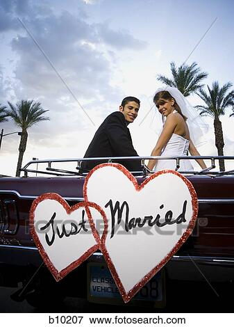 Portrait of a newlywed couple sitting in a car and smiling View Large Photo Image Stock Photo - Portrait of a newlywed couple sitting in a car and smiling. Fotosearch
