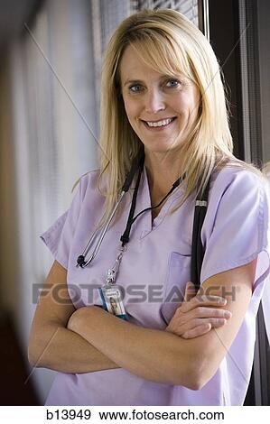 Portrait of a nurse with arms crossed smiling View Large Photo Image Stock Photo - Portrait of a nurse with arms crossed smiling. Fotosearch