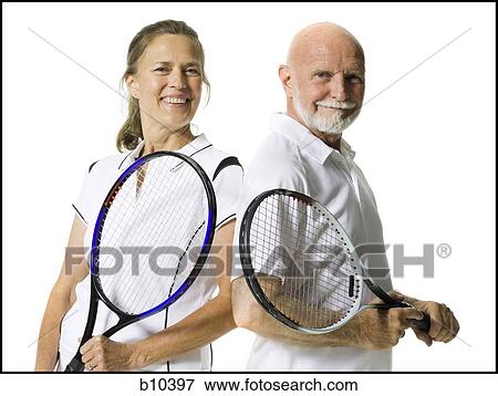 Portrait of a senior couple standing with tennis rackets View Large Photo Image Stock Photo - Portrait of a senior couple standing with tennis rackets. Fotosearch