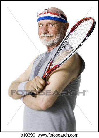 Portrait of a senior man holding a tennis racket View Large Photo Image Stock Image - Portrait of a senior man holding a tennis racket. Fotosearch