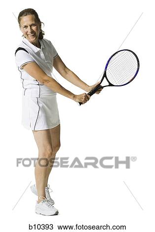 Portrait of a senior woman holding a tennis racket and smiling View Large Photo Image Stock Image - Portrait of a senior woman holding a tennis racket and smiling. Fotosearch