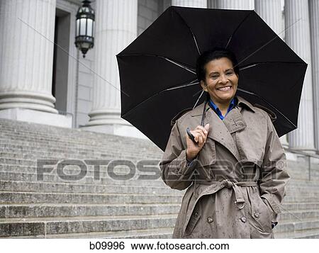 Portrait of a senior woman holding an umbrella View Large Photo Image Stock Photograph - Portrait of a senior woman holding an umbrella. Fotosearch