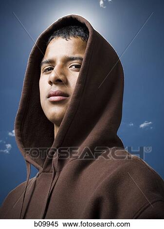 Portrait of a teenage boy wearing a hoodie View Large Photo Image Stock Photography - Portrait of a teenage boy wearing a hoodie. Fotosearch