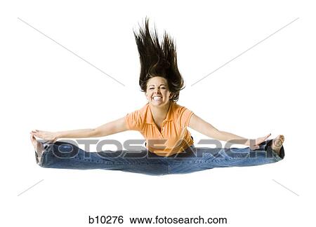 Portrait of a teenage girl doing the splits in mid-air View Large Photo Image Stock Photograph - Portrait of a teenage girl doing the splits in mid-air. Fotosearch