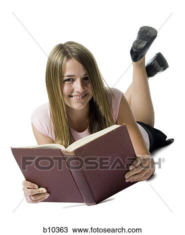 Portrait of a teenage girl lying down and holding a book View Large Photo Image Stock Image - Portrait of a teenage girl lying down and holding a book. Fotosearch