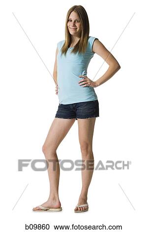 Stock Image - Portrait of a teenage girl standing with her hands on her hips. Fotosearch