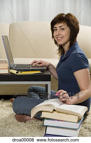 Portrait of a teenage girl using a laptop and smiling View Large Photo Image Stock Photo - Portrait of a teenage girl using a laptop and smiling. Fotosearch