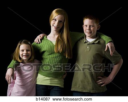 Portrait of a teenage girl with boy and young girl embracing and smiling View Large Photo Image Stock Photo - Portrait of a teenage girl with boy and young girl embracing and smiling. Fotosearch