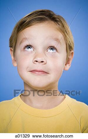 Portrait of a young boy looking up View Large Photo Image Stock Photo - Portrait of a young boy looking up. Fotosearch