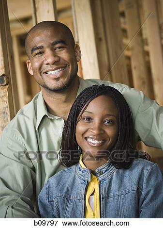 Stock Photo - Portrait of a young couple smiling. Fotosearch