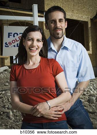 Stock Photograph - Portrait of a young couple smiling. Fotosearch