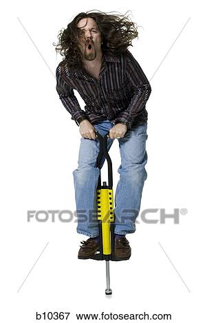 Portrait of a young man standing on a pogo stick View Large Photo Image Stock Photo - Portrait of a young man standing on a pogo stick. Fotosearch