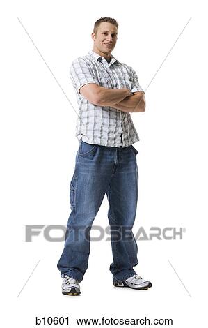 Portrait of a young man standing with his arms crossed View Large Photo Image Stock Image - Portrait of a young man standing with his arms crossed. Fotosearch
