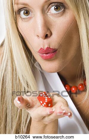 Portrait of a young woman holding a pair of dice View Large Photo Image Picture - Portrait of a young woman holding a pair of dice. Fotosearch