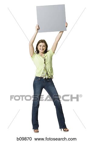 Portrait of a young woman holding a blank sign View Large Photo Image Stock Image - Portrait of a young woman holding a blank sign. Fotosearch