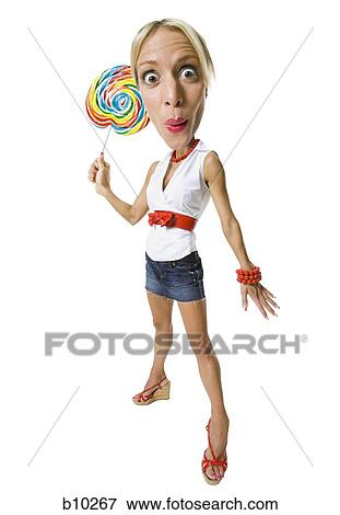 Stock Photo - Portrait of a young woman holding a lollipop. Fotosearch