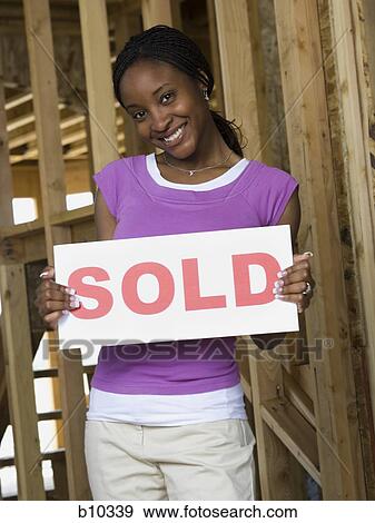 Portrait of a young woman holding an information board View Large Photo Image Stock Photo - Portrait of a young woman holding an information board. Fotosearch