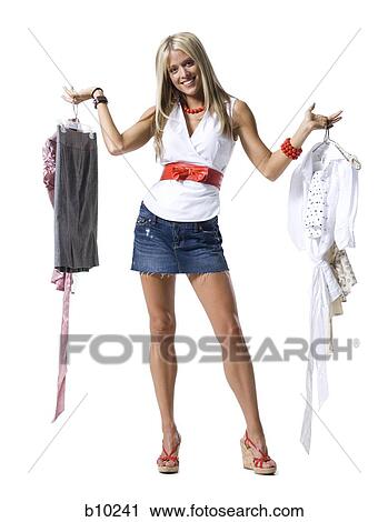 Portrait of a young woman holding dresses View Large Photo Image Stock Image - Portrait of a young woman holding dresses. Fotosearch