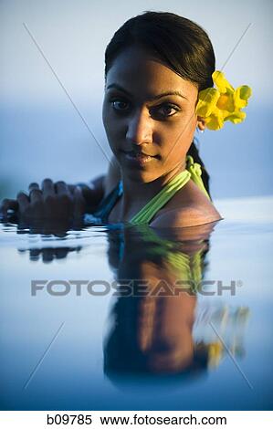 Stock Photography - Portrait of a young woman in a swimming pool. Fotosearch