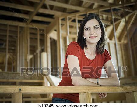 Portrait of a young woman leaning against a railing View Large Photo Image Stock Photography - Portrait of a young woman leaning against a railing. Fotosearch