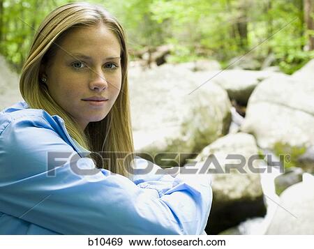 Stock Photo - Portrait of a young woman looking serious. Fotosearch