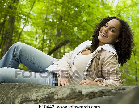 Portrait of a young woman lying down View Large Photo Image Stock Image - Portrait of a young woman lying down. Fotosearch