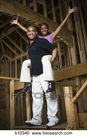 Portrait of a young woman riding piggyback on a young man View Large Photo Image Stock Image - Portrait of a young woman riding piggyback on a young man. Fotosearch