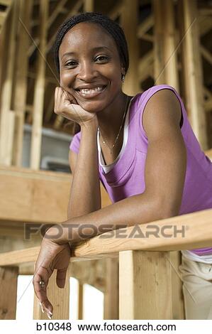 Portrait of a young woman smiling View Large Photo Image Stock Photo - Portrait of a young woman smiling. Fotosearch