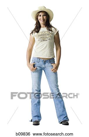 Stock Photograph - Portrait of a young woman standing with her hands in her pockets. Fotosearch