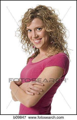 Portrait of a young woman with her arms crossed View Large Photo Image Stock Photo - Portrait of a young woman with her arms crossed. Fotosearch