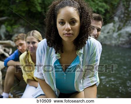Portrait of a young woman with her friend in the background View Large Photo Image Stock Photo - Portrait of a young woman with her friend in the background. Fotosearch