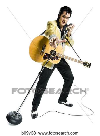 Portrait of an Elvis impersonator singing into a microphone View Large Photo Image Stock Photo - Portrait of an Elvis impersonator singing into a microphone. Fotosearch