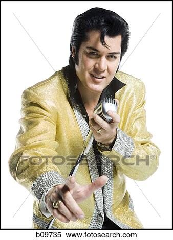 Portrait of an Elvis impersonator singing into a microphone View Large Photo Image Stock Photography - Portrait of an Elvis impersonator singing into a microphone. Fotosearch