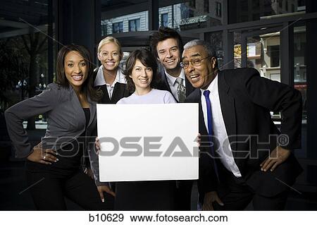 Portrait of five business executives standing with a blank sign View Large Photo Image Stock Photo - Portrait of five business executives standing with a blank sign. Fotosearch