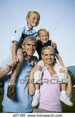 Portrait of parents carrying their two children on their shoulders View Large Photo Image Stock Photography - Portrait of parents carrying their two children on their shoulders. Fotosearch