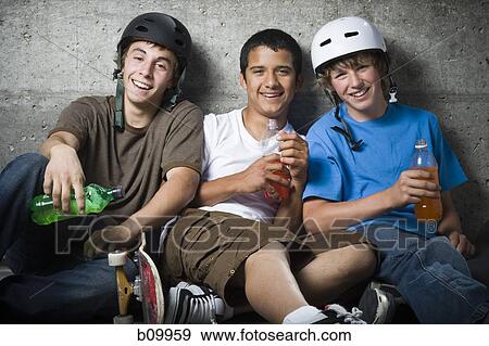 Stock Photo - Portrait of three teenage boys smiling. Fotosearch