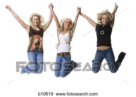 Stock Photo - Portrait of three young women holding hands and jumping. Fotosearch