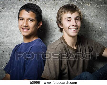 Stock Image - Portrait of two teenage boys smiling. Fotosearch