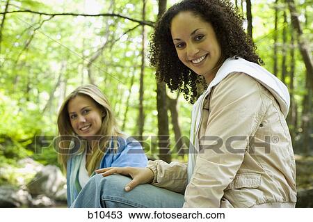 Portrait of two young women smiling View Large Photo Image Stock Image - Portrait of two young women smiling. Fotosearch