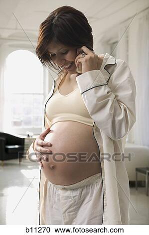 Pregnant woman talking on phone View Large Photo Image Stock Image - Pregnant woman talking on phone. Fotosearch