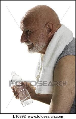 Profile of a senior man holding a bottle of water View Large Photo Image Stock Image - Profile of a senior man holding a bottle of water. Fotosearch