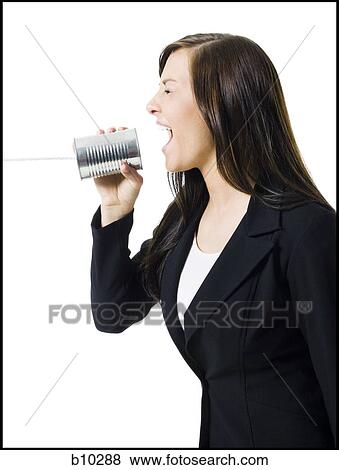 Profile of a teenage girl holding a tin can phone and shouting View Large Photo Image Stock Photo - Profile of a teenage girl holding a tin can phone and shouting. Fotosearch