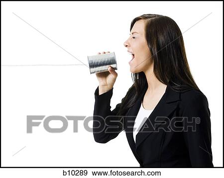 Profile of a teenage girl holding a tin can phone and shouting View Large Photo Image Stock Photo - Profile of a teenage girl holding a tin can phone and shouting. Fotosearch