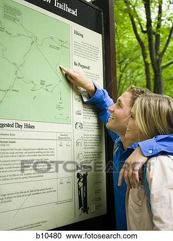 Profile of a young couple looking at a map View Large Photo Image Stock Image - Profile of a young couple looking at a map. Fotosearch