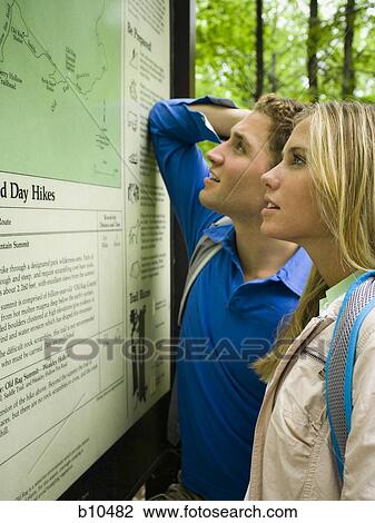 Profile of a young couple looking at a map View Large Photo Image Stock Image - Profile of a young couple looking at a map. Fotosearch