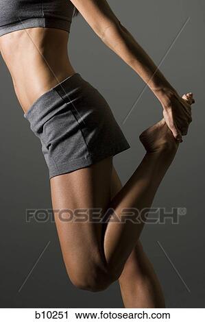 Profile of a young woman stretching View Large Photo Image Stock Image - Profile of a young woman stretching. Fotosearch